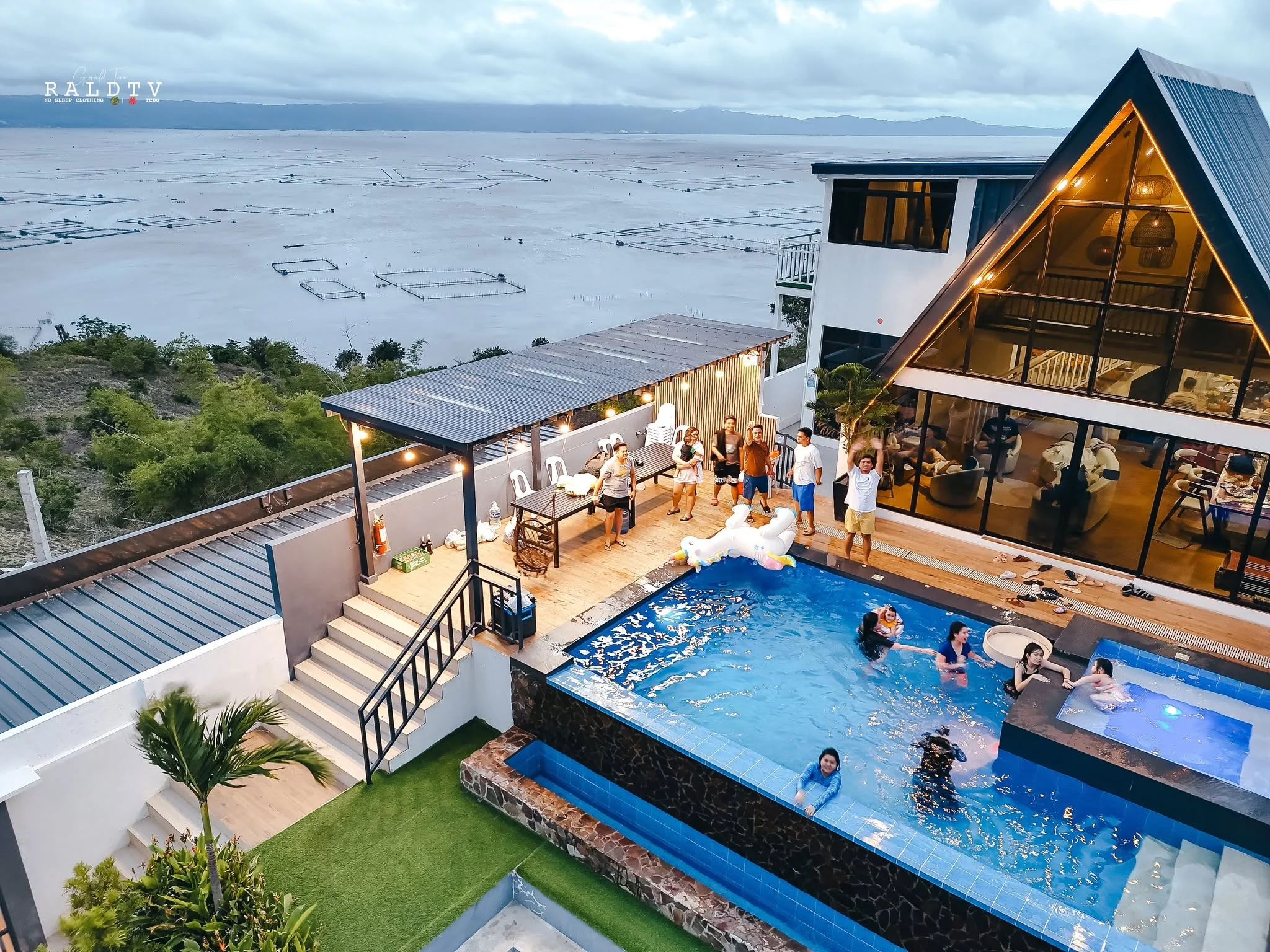 Guests gathered around a villa pool at dusk at City on a Hill