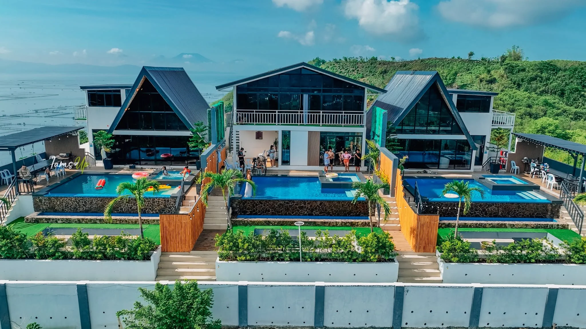 A daylight aerial showing the three villas and their pools at City on a Hill