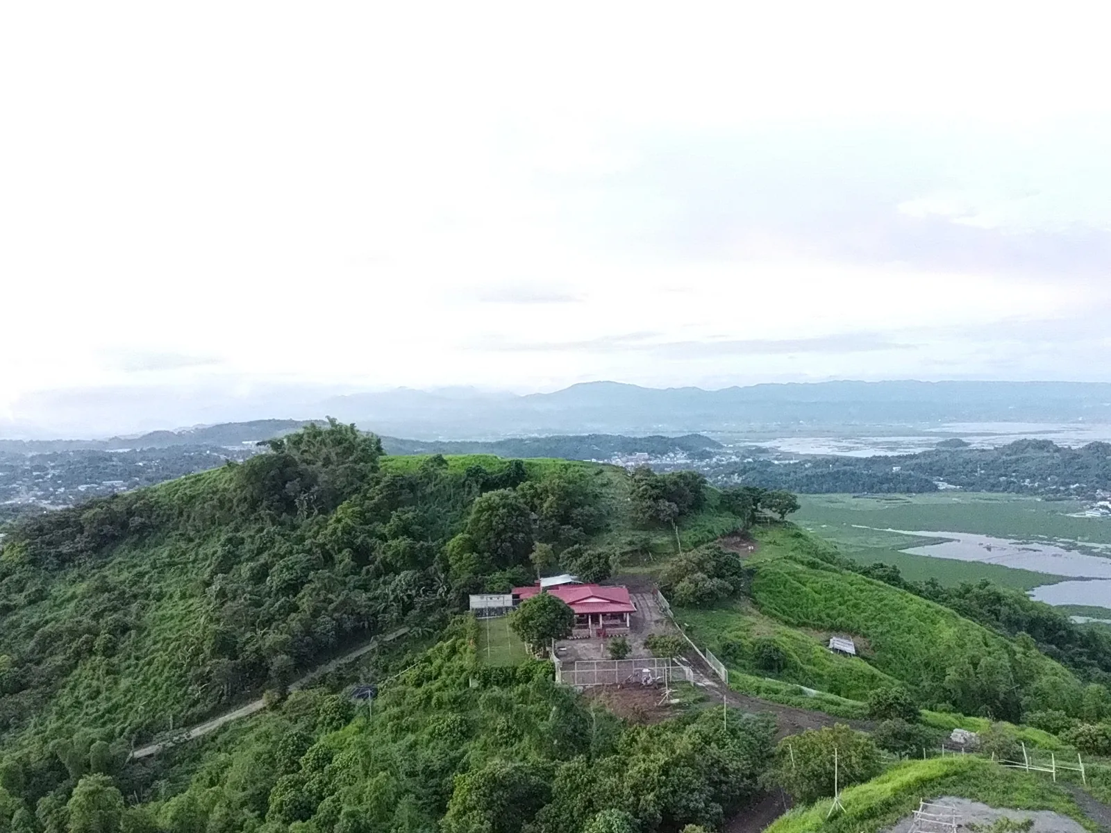 Aerial view of the green hillside and Laguna Lake around Mahabang Parang, Binangonan, Rizal