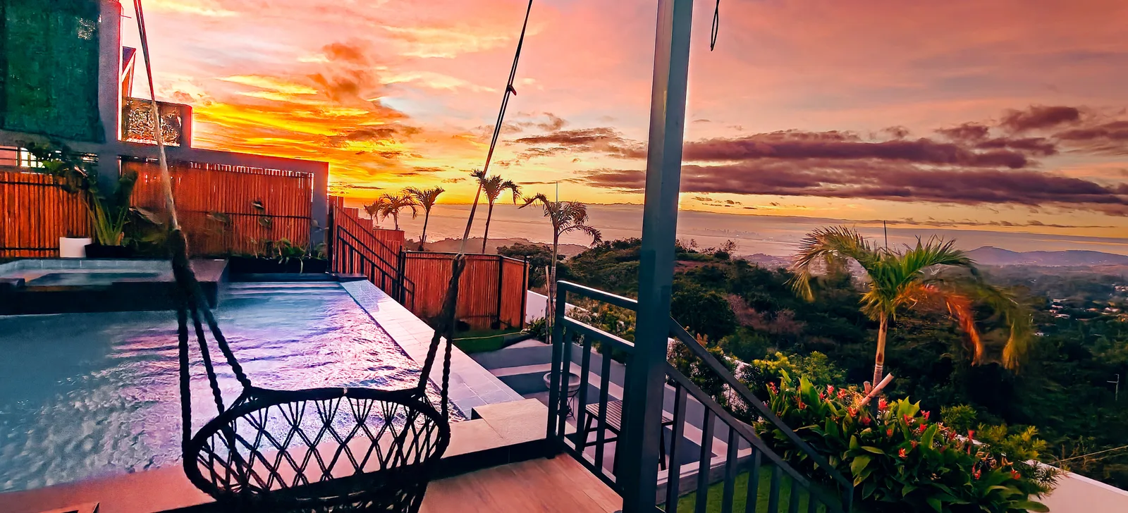 A hanging chair on a villa terrace at sunset at City on a Hill, Binangonan