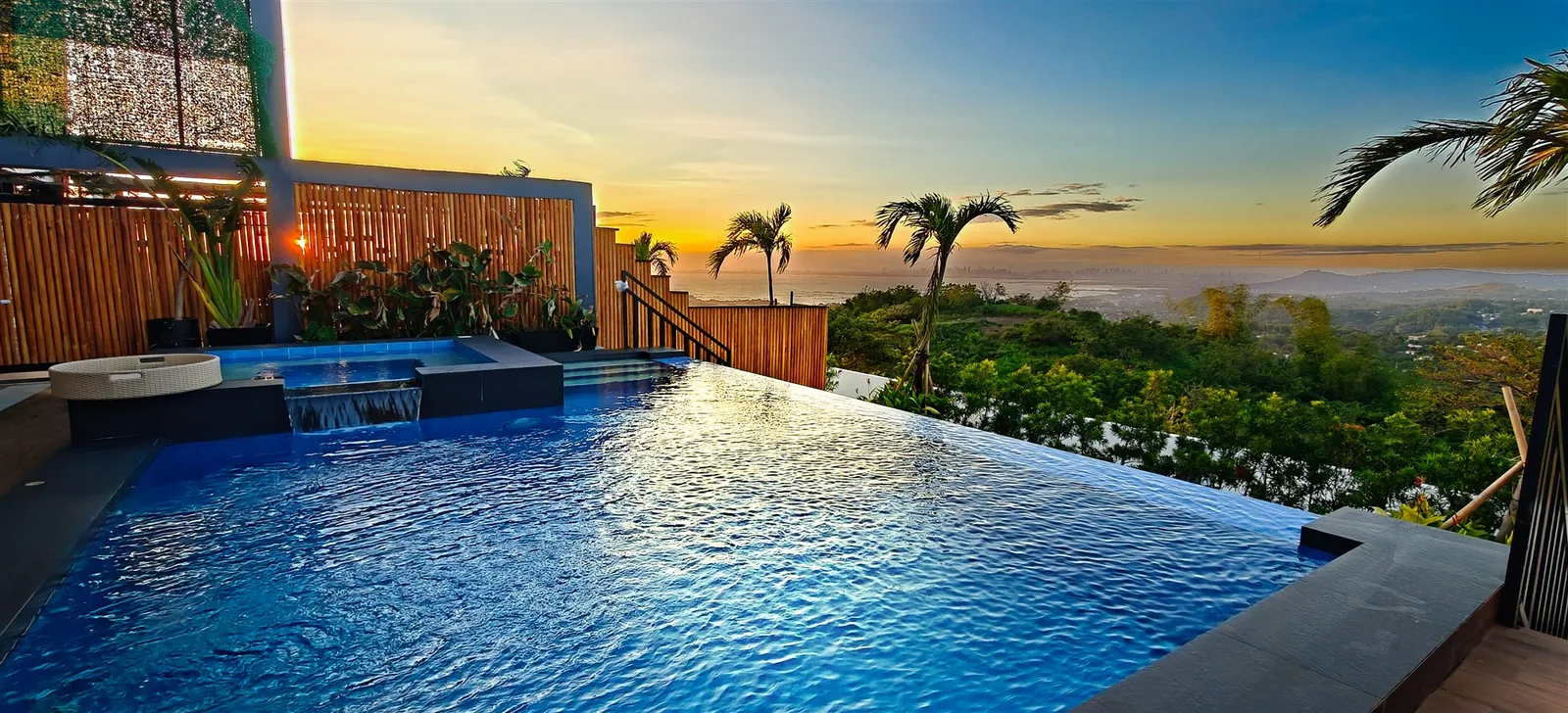 An infinity pool edge at sunset over the Rizal landscape at City on a Hill, Binangonan