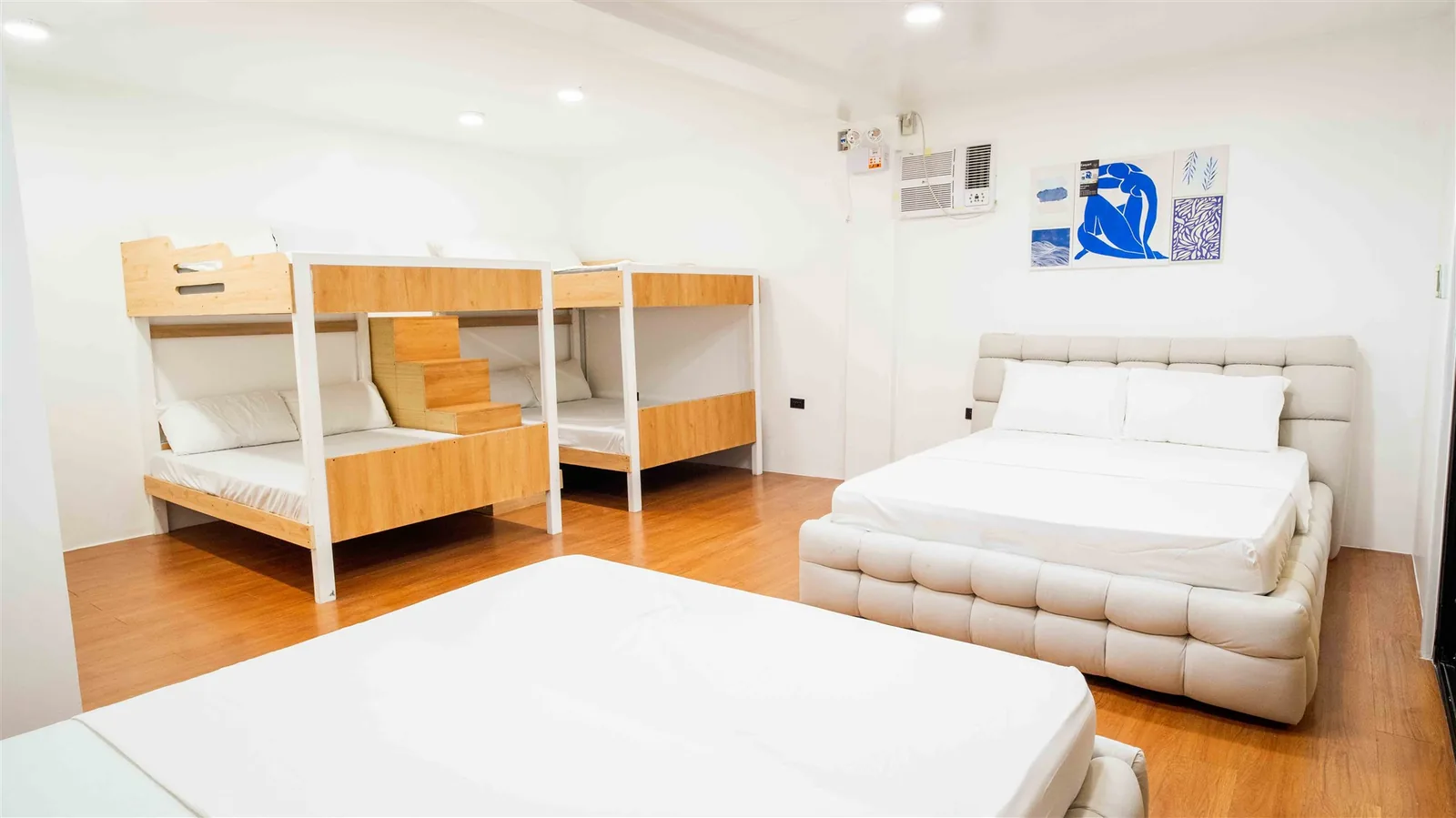Zoie villa bedroom with a large bed, double bunk beds and a sofa bed